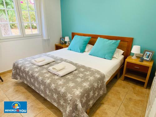 a bedroom with a bed with two towels on it at Safir in Son Bou