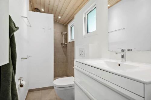 a white bathroom with a sink and a toilet at 30459-Odder-Solskraenten-2 in Odder