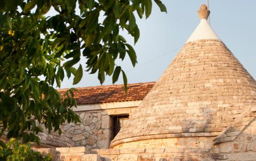 a stone building with a brick roof with a window at Dimora Casanoja in Noci