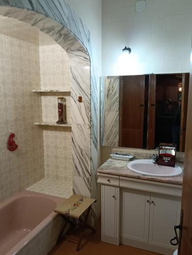 a bathroom with a tub and a sink and a bath tub at Sa Torre in Campos