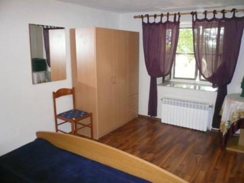 a living room with a bed and a window at Apartment Nono Anton in Kraljevica