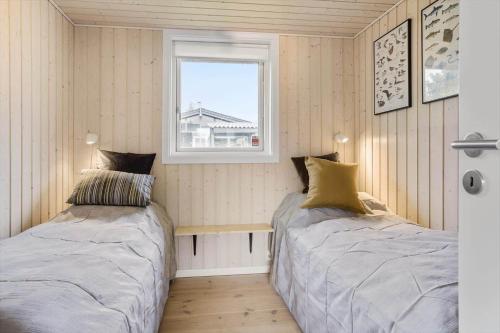 two beds in a small room with a window at 30178-Odder-Chr-Christensensvej-9 in Beder