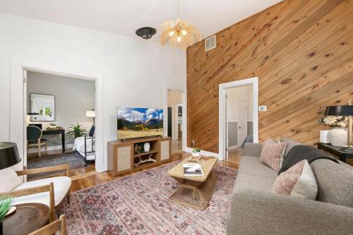 a living room with a couch and a table at Oak Street Bungalow Walk to Old Town and CSU in Buckingham