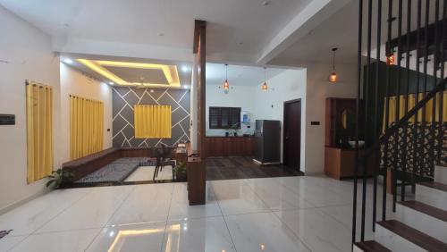a hallway of a house with yellow doors and stairs at Roameo, Varkala - A Cowork by The Hostel Stories in Varkala