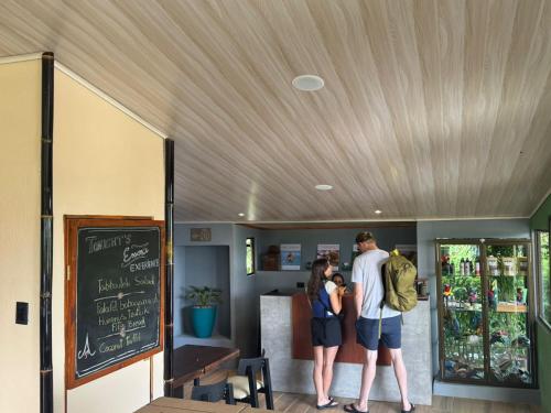 un hombre y una mujer de pie en un restaurante en Essence Arenal Spa & Yoga, en El Castillo de La Fortuna