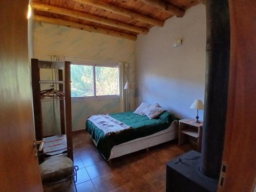 a bedroom with a bed and a window at Dejavú in San Marcos Sierras