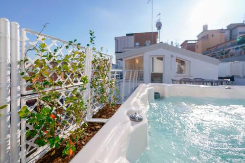 a hot tub in a backyard with a fence at The Rooftop in Bologna