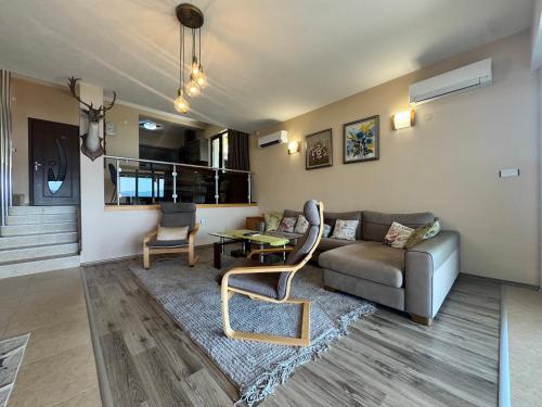 a living room with a couch and a table at Penev guest house in Glavatartsi