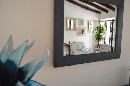 a mirror on a wall with a plant in front of it at Can Font in Sineu