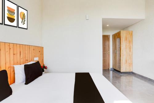 Ένα ή περισσότερα κρεβάτια σε δωμάτιο στο HOTEL O OLIVE HOTEL