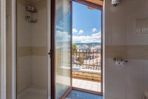 a glass shower door with a view of a pool at Hotel Conte Ruggero in Serra San Bruno