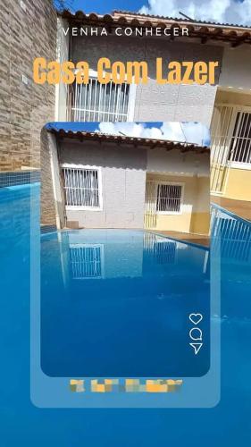 a swimming pool in front of a building at Casa Com Lazer 8 anos in Cidade Ocidental