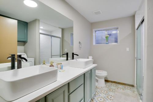 a bathroom with two sinks and a toilet at 6 Mi to Barr Lake Apt with Hot Tub Access! in Brighton