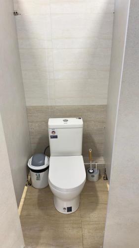 a bathroom with a toilet in a small room at Arzum Hostel in Tashkent