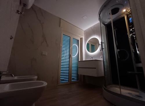 a bathroom with two sinks and a shower and a mirror at B&B antonia in SantʼAntonio Abate