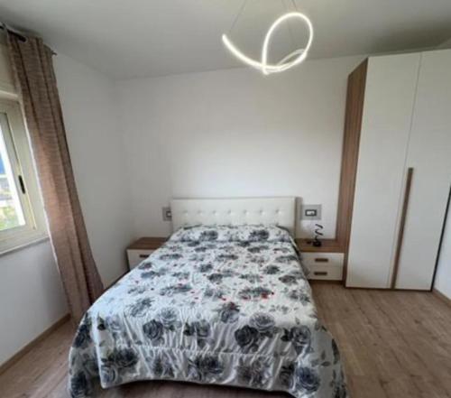 a bedroom with a bed with a comforter on it at B&B antonia in SantʼAntonio Abate
