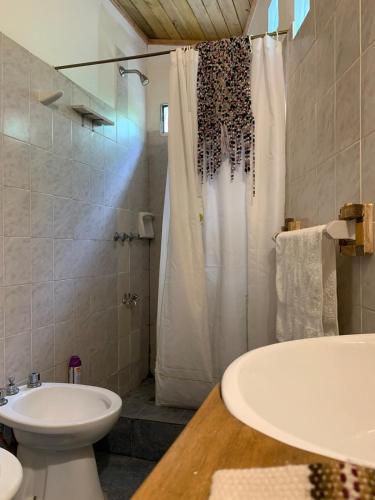 a bathroom with a sink and a toilet and a shower at Espacio Kaskai in San Marcos Sierras