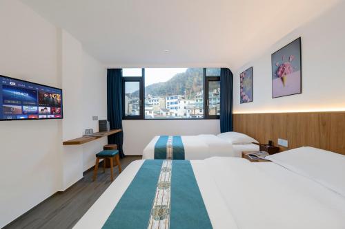 Postel nebo postele na pokoji v ubytování Huang Mountain Wangfeng Hotel