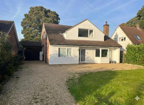a large white house with a driveway at Grand 5BR Home in Market Harborough with Parking in Market Harborough