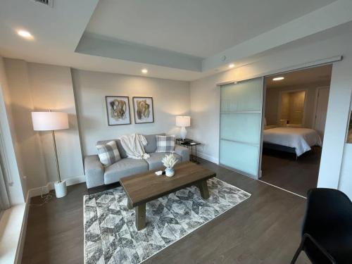 a living room with a couch and a bed at Downtown bright cozy & modern 1 Bedroom in Halifax