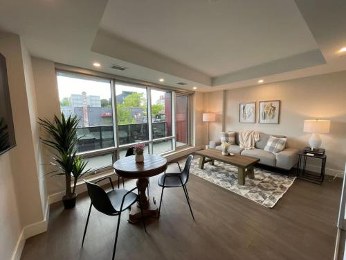 a living room with a couch and a table and chairs at Downtown bright cozy & modern 1 Bedroom in Halifax