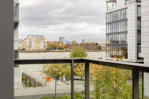 a view of a river from a balcony of a building at Stylish Greenwich Apartment with Balcony And River Views in London
