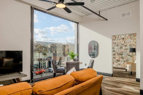 a living room with a couch and a large window at Modern City View 1BR Apartment with Office - free parking in Appleton