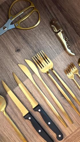 a group of gold forks and knives on a table at âme casa in Mesochórion