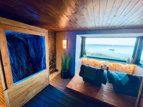 a room with a couch and a large window at REWA CZTERY PORY ROKU in Rewa