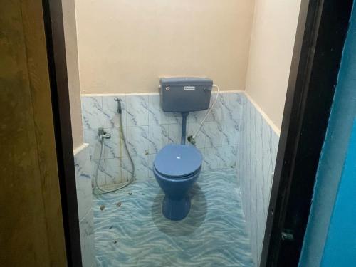 a bathroom with a blue toilet in the water at The Ultimate stay in Puducherry