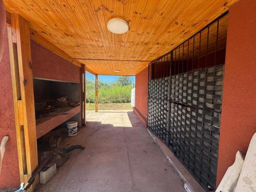 an empty hallway of a building with a wooden ceiling at casa con vista 360 a las sierras y pileta in Bialet Massé