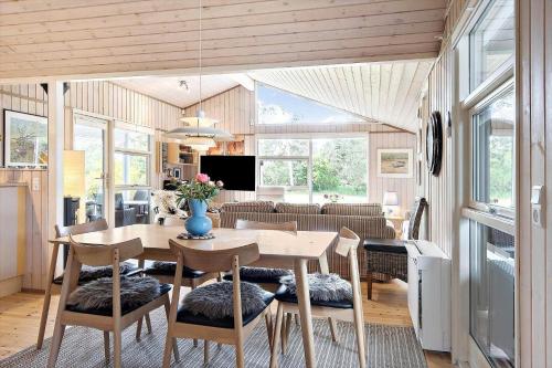 a dining room and living room with a table and chairs at SL070-Slagelse-Snerlevej-2 in Slagelse