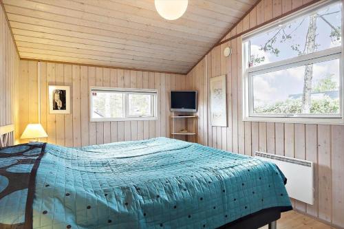 a bedroom with a bed and a television in it at SL070-Slagelse-Snerlevej-2 in Slagelse