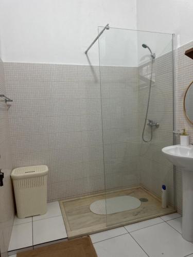a bathroom with a shower and a toilet and a sink at T2 Vacation in Mindelo in Mindelo