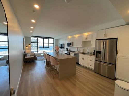 a kitchen and living room with a table and appliances at Waterfront large 1 BR with 6 appliances & gym in Halifax