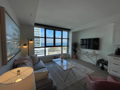 a living room with a couch and a table at Waterfront large 1 BR with 6 appliances & gym in Halifax