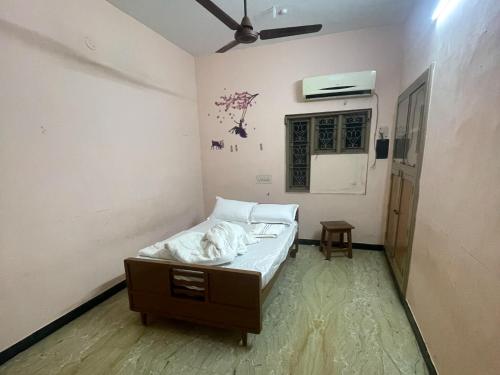 a small room with a bed and a fan at The Ultimate stay in Puducherry