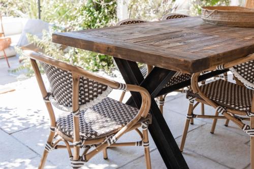 a wooden table and chairs on a patio at BURGUNDY house in Grândola