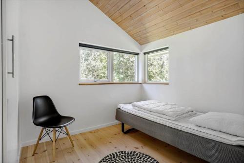 a bedroom with a bed and a chair in it at K19089-Kalundborg-Granlygardsvej-30 in Ågerup