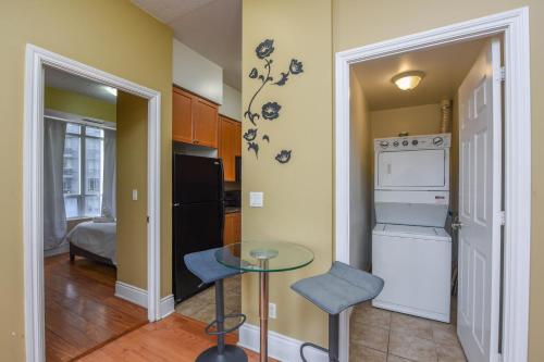 a kitchen with a stove and a table in a room at PlanURstay - Ideal 2BR & 2 BTH - Near SQ1 Mall in Mississauga