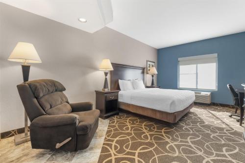 een hotelkamer met een bed en een stoel bij Best Western Plus Eau Claire Conference Center in Eau Claire
