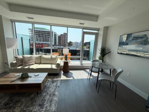 a living room with a couch and a table at Downtown Bright & Vibrant 1 BR with huge patio in Halifax