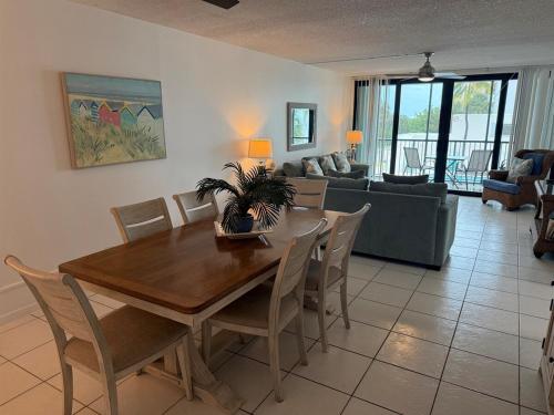 a dining room and living room with a table and chairs at Bird of Paradise in Marathon