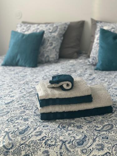 a pair of scissors sitting on top of a bed at CreaConfort Casa Boa Jóia de Campanhã in Porto