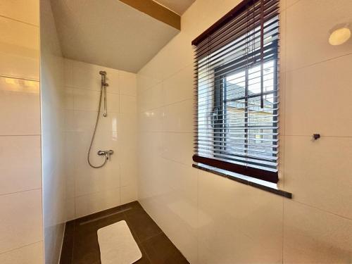 a bathroom with a shower and a window at Petit Wilogne in Dinez