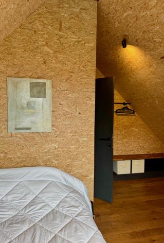 a bedroom with a bed and a wall at Chez Madeline in Hannut