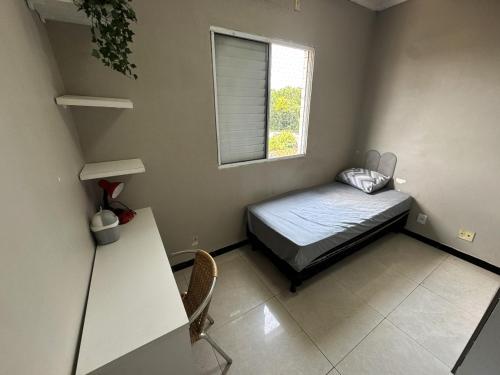 a small bedroom with a bed and a window at Ap Cop 30 in Belém