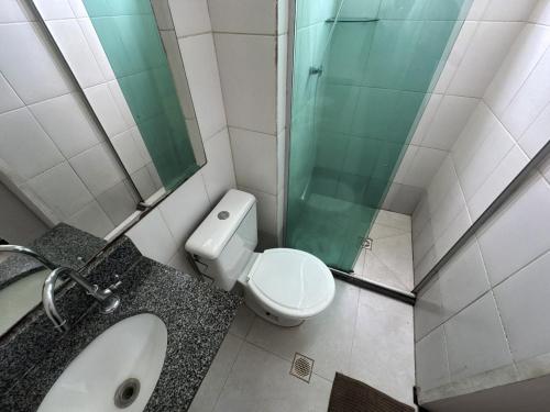 a bathroom with a toilet and a sink and a shower at Ap Cop 30 in Belém