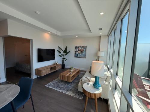 a living room with a couch and a table at Penthouse downtown 1 Bedroom with 6 appliances in Halifax