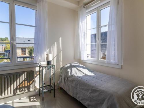 a bedroom with a bed and two windows at Gîte familial pour 8 pers. à Saint Aubin de Luigné - FR-1-622-117 in Saint-Aubin-de-Luigné